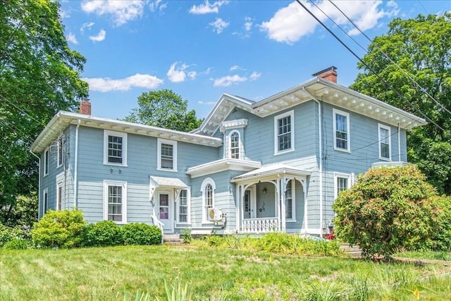 1 Nelson St Unit C, Upton, MA 01568 - view of front of house featuring a chimney, a porch, and a front lawn