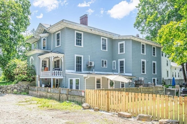 1 Nelson St Unit C, Upton, MA 01568 - back of house featuring a chimney and a balcony