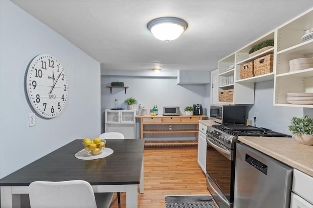 1 Nelson St Unit C, Upton, MA 01568 - kitchen with appliances with stainless steel finishes, open shelves, light wood-style floors, light countertops, and white cabinetry