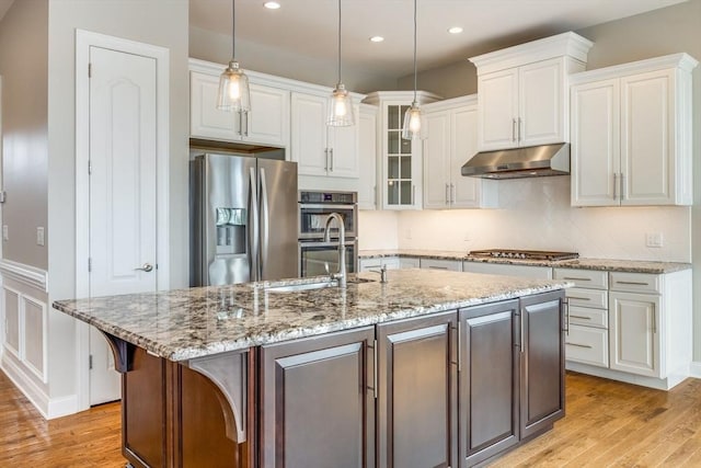 12 Skipping Stone, Plymouth, MA 02360 - kitchen with appliances with stainless steel finishes, under cabinet range hood, a sink, white cabinetry, and light wood-style flooring