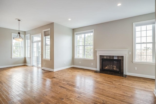 12 Skipping Stone, Plymouth, MA 02360 - unfurnished living room with wood-type flooring, baseboards, a premium fireplace, and recessed lighting