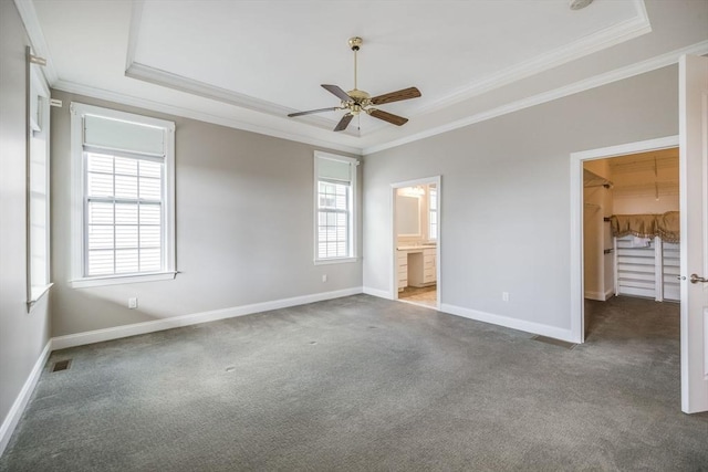 12 Skipping Stone, Plymouth, MA 02360 - unfurnished bedroom with ornamental molding, a raised ceiling, carpet floors, baseboards, and a walk in closet