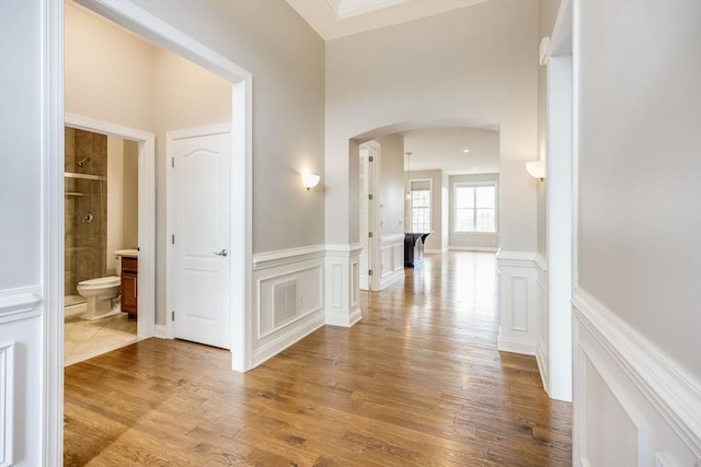 12 Skipping Stone, Plymouth, MA 02360 - corridor featuring arched walkways, wood finished floors, and wainscoting