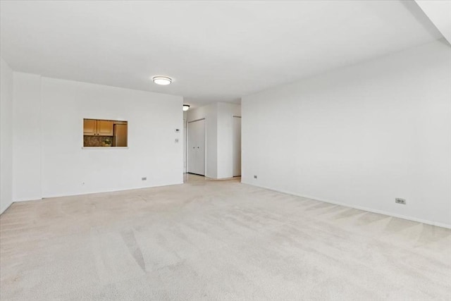 empty room featuring light carpet