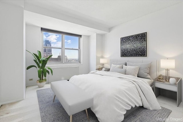 bedroom with baseboards and light colored carpet
