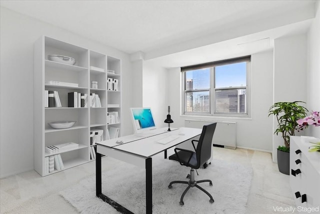 office featuring baseboards, carpet, and radiator