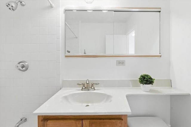 bathroom featuring vanity, toilet, and a shower