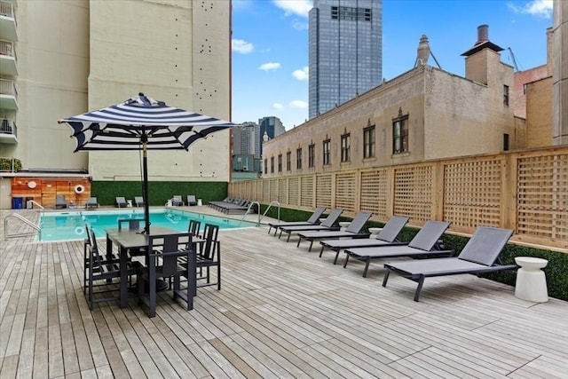 wooden deck featuring a community pool