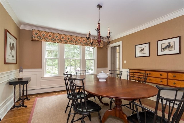 617 S St, Needham, MA 02492 - dining room featuring a chandelier, wood finished floors, ornamental molding, a wainscoted wall, and baseboard heating