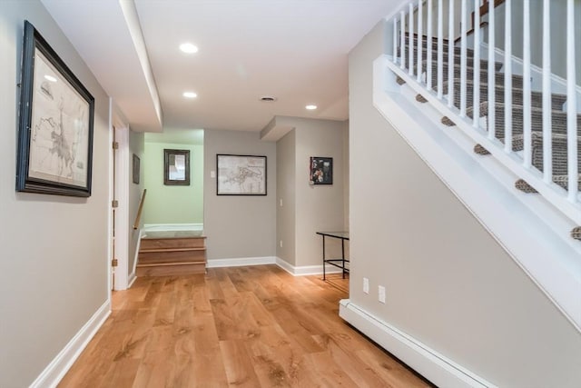 617 S St, Needham, MA 02492 - hallway featuring a baseboard heating unit, stairs, light wood-style floors, recessed lighting, and baseboards