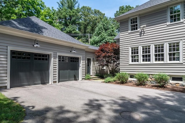 617 S St, Needham, MA 02492 - view of side of home featuring driveway, a shingled roof, and a garage