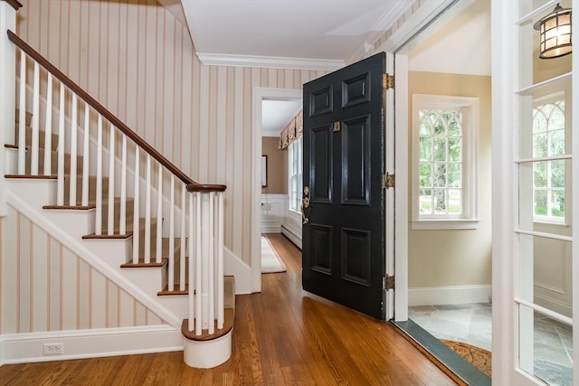 617 S St, Needham, MA 02492 - foyer entrance featuring wallpapered walls, wood finished floors, baseboards, stairs, and baseboard heating