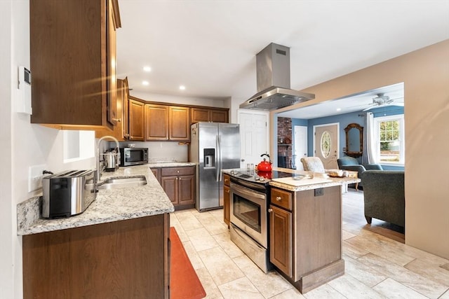 kitchen with a center island, island exhaust hood, stainless steel appliances, open floor plan, and a sink