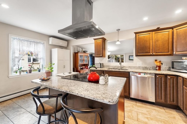 kitchen featuring island range hood, a breakfast bar, a wall mounted air conditioner, stainless steel appliances, and a sink