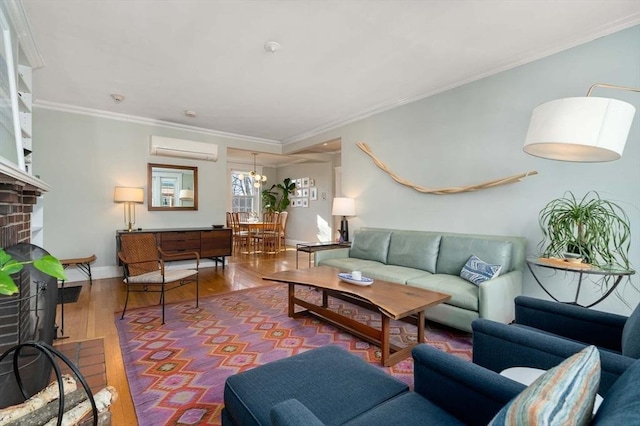 59 Babcock St Unit 5, Brookline, MA 02446 - living room with a wall unit AC, wood finished floors, a brick fireplace, ornamental molding, and a chandelier