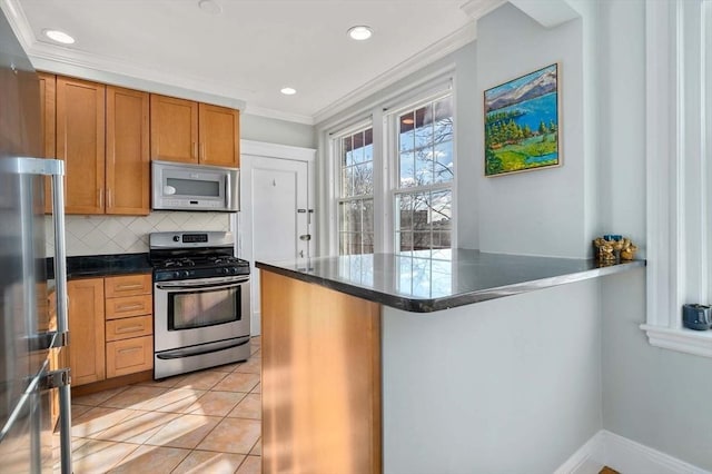 59 Babcock St Unit 5, Brookline, MA 02446 - kitchen featuring stainless steel gas stove, ornamental molding, dark countertops, brown cabinetry, and decorative backsplash