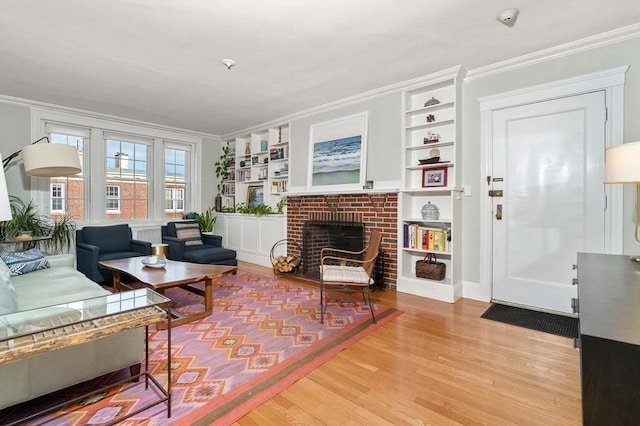 59 Babcock St Unit 5, Brookline, MA 02446 - living area with ornamental molding, wood finished floors, built in features, and a brick fireplace