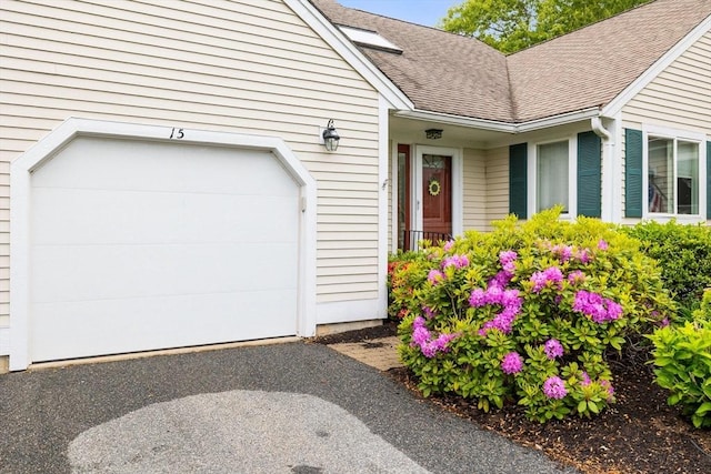 15 Pebble Bch Unit 2005-103, Mashpee, MA 02649 - property entrance with roof with shingles, an attached garage, and driveway