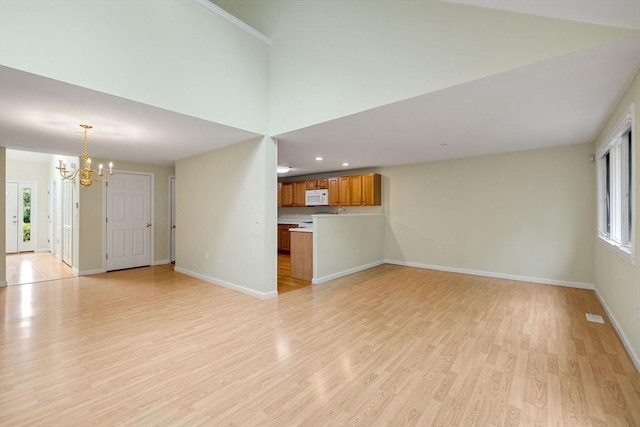 15 Pebble Bch Unit 2005-103, Mashpee, MA 02649 - unfurnished living room with a chandelier, light wood-type flooring, and recessed lighting