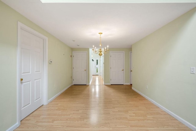 15 Pebble Bch Unit 2005-103, Mashpee, MA 02649 - unfurnished dining area featuring a chandelier and light wood-style flooring