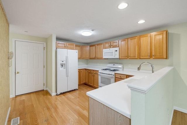 15 Pebble Bch Unit 2005-103, Mashpee, MA 02649 - kitchen with white appliances, light wood-style flooring, light countertops, a peninsula, and recessed lighting