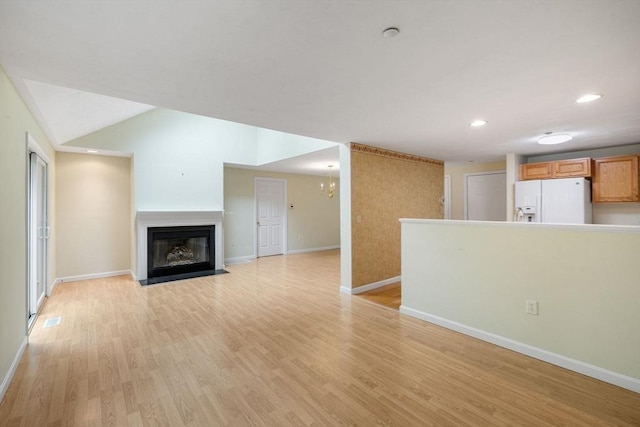 15 Pebble Bch Unit 2005-103, Mashpee, MA 02649 - unfurnished living room featuring light wood finished floors, a fireplace with flush hearth, and recessed lighting