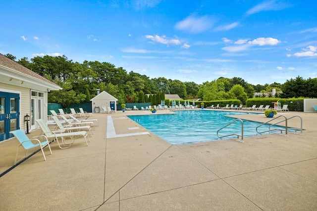 15 Pebble Bch Unit 2005-103, Mashpee, MA 02649 - community pool featuring a patio, view of scattered trees, and french doors