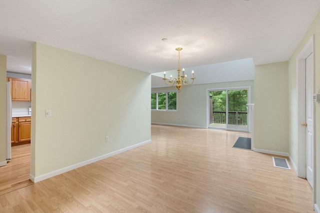 15 Pebble Bch Unit 2005-103, Mashpee, MA 02649 - empty room featuring light wood-style flooring and a chandelier