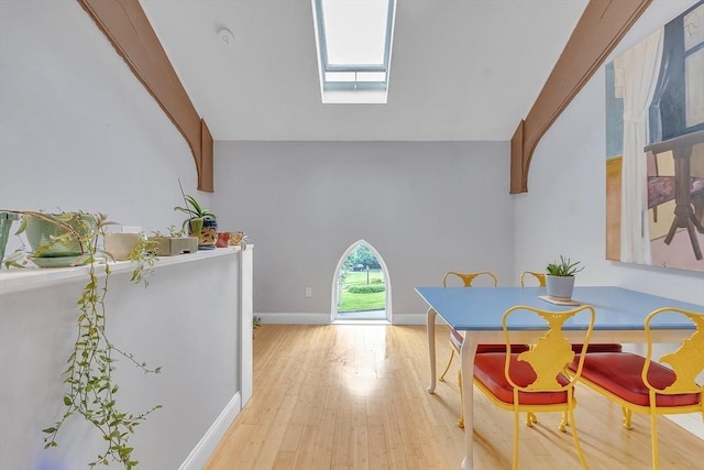28 Broad St Unit 203, Marlborough, MA 01752 - dining space with a skylight, wood finished floors, and lofted ceiling