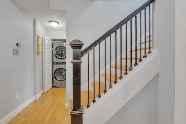 28 Broad St Unit 203, Marlborough, MA 01752 - stairs featuring stacked washer / dryer and wood finished floors