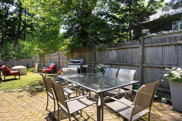 86 Waban Ave, Newton, MA 02468 - fenced backyard featuring outdoor dining space, a patio, and a grill