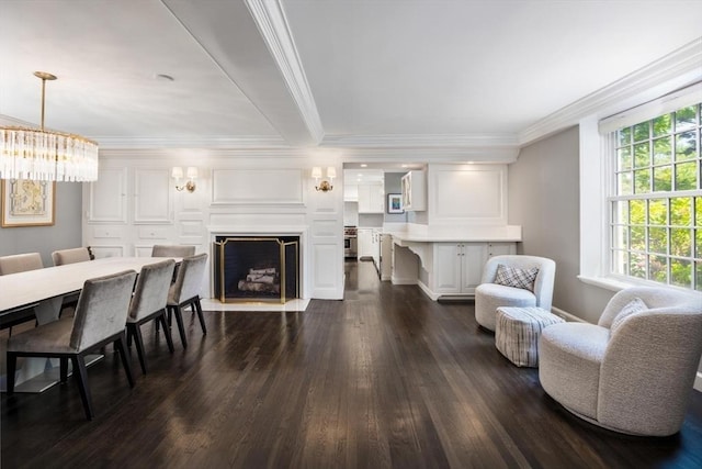 86 Waban Ave, Newton, MA 02468 - living area with dark wood-style flooring, crown molding, a fireplace with flush hearth, and a chandelier