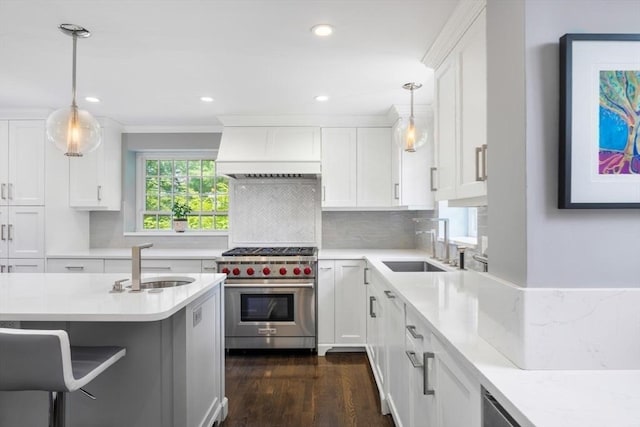 86 Waban Ave, Newton, MA 02468 - kitchen with designer range, white cabinetry, hanging light fixtures, dark wood-type flooring, and recessed lighting