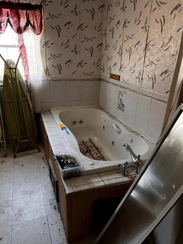 bathroom with a tub to relax in