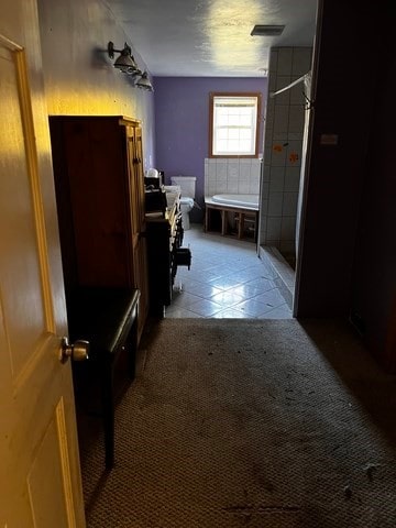 bathroom featuring toilet, tile patterned flooring, vanity, and walk in shower