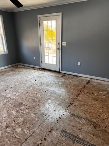 spare room featuring ornamental molding, ceiling fan, and plenty of natural light