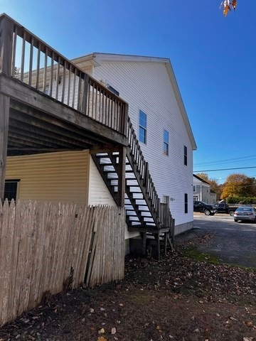 view of side of home featuring a wooden deck