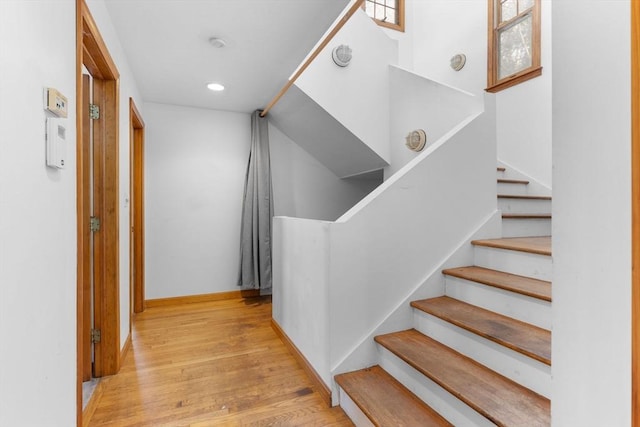 stairway with hardwood / wood-style floors