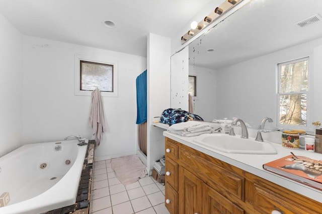 bathroom featuring vanity, a bathing tub, and tile patterned flooring