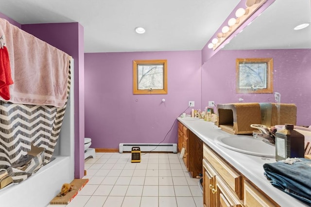 bathroom featuring baseboard heating, tile patterned floors, vanity, and toilet