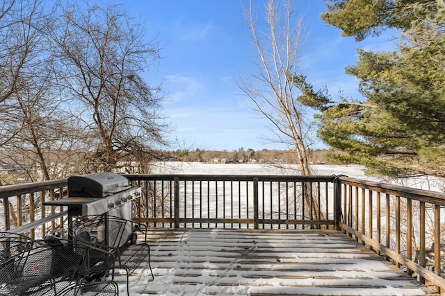 snow covered deck featuring a grill