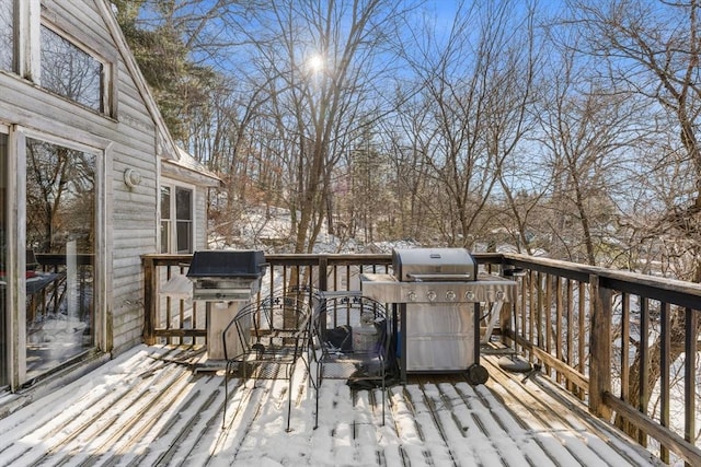 snow covered deck featuring a grill