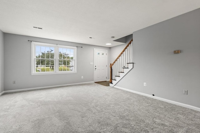 728 Auburn St Unit E4, Whitman, MA 02382 - unfurnished living room featuring stairs and carpet flooring