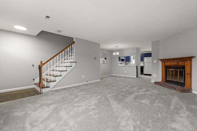 728 Auburn St Unit E4, Whitman, MA 02382 - unfurnished living room featuring carpet, stairway, a fireplace, and a chandelier