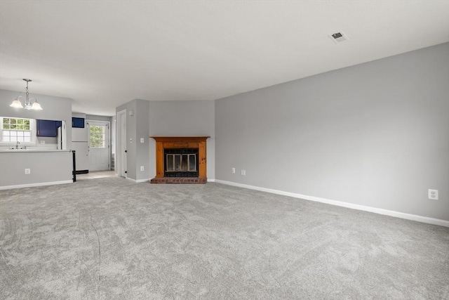 728 Auburn St Unit E4, Whitman, MA 02382 - unfurnished living room featuring a chandelier, light colored carpet, and a fireplace