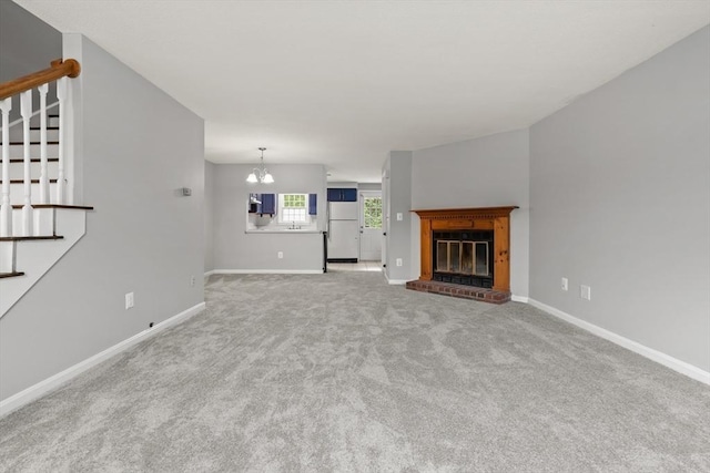 728 Auburn St Unit E4, Whitman, MA 02382 - unfurnished living room with stairway, carpet flooring, a brick fireplace, and a chandelier