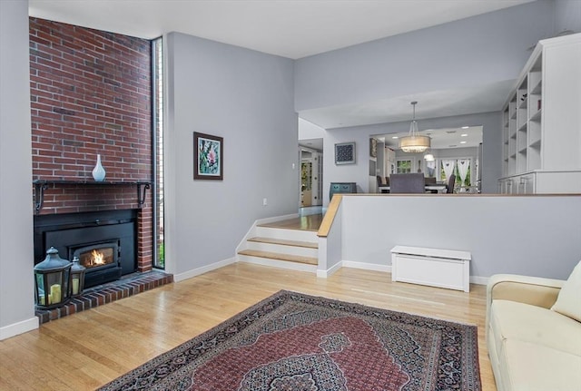 4 Benjamin Pl Unit 4, Brookline, MA 02467 - living area featuring wood finished floors and a brick fireplace
