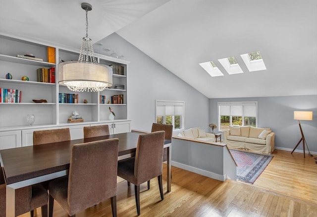 4 Benjamin Pl Unit 4, Brookline, MA 02467 - dining area featuring a skylight, light wood-style floors, and high vaulted ceiling