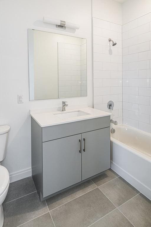 full bathroom featuring tile patterned floors, tiled shower / bath combo, toilet, and vanity