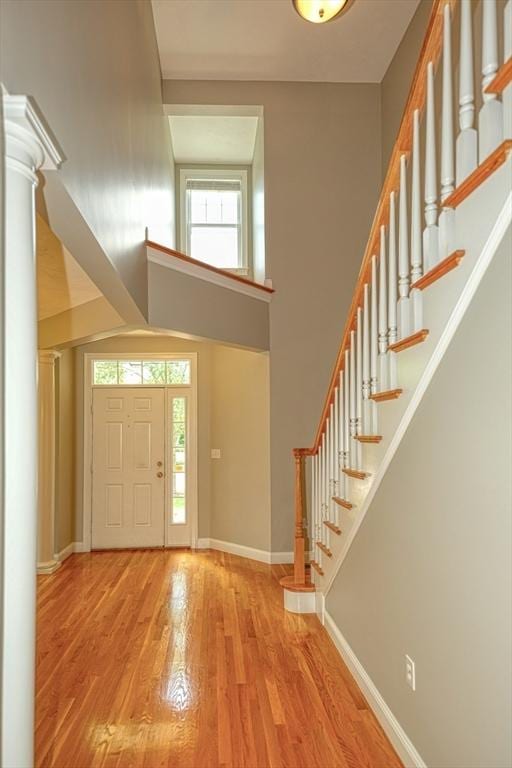 39 Balancing Rock Dr Unit 39, Holliston, MA 01746 - entryway featuring wood finished floors, ornate columns, stairs, and a high ceiling